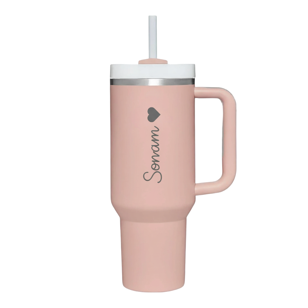 Pink tumbler with handle and straw on a light gray background