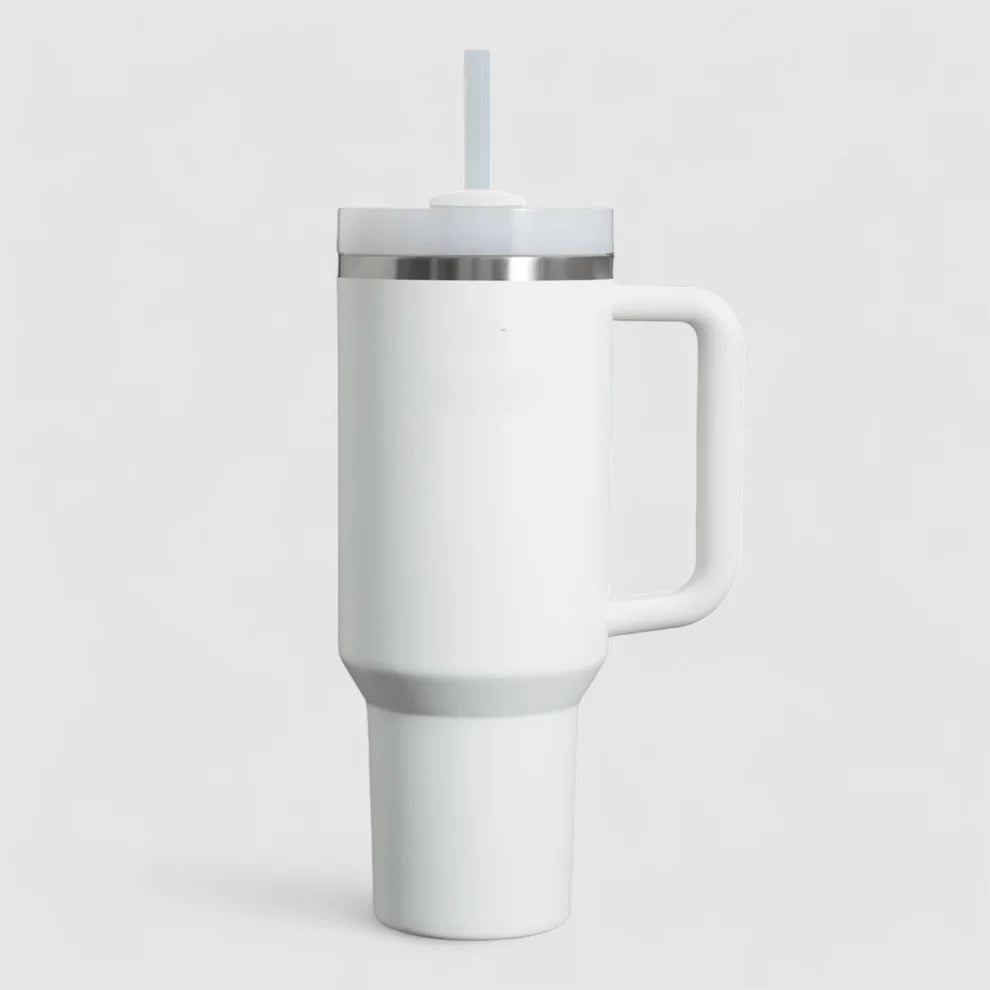 White insulated tumbler with a silver lid on a light gray background